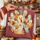 Patchwork quilted turkey DTF transfer with floral fabric feathers, 'thankful' and 'give thanks' lettering, for Thanksgiving fall shirts