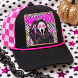Ghostface Halloween DTF transfer with hooded killer wearing pink star-shaped glasses, polka dot background, and gold glitter border Shown on a black front panel, black bill, hot pink and white checkered mesh back trucker hat.