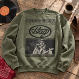 Vintage newspaper-style Hag DTF transfer with The Country Daily masthead and halftone photo of a classic country singer with guitar and bottle Shown on a Military Green crewneck sweatshirt.