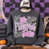 It's Freakin' Bats Halloween DTF transfer with distressed pink and purple lettering, three cartoon bats, and gold sparkle accents Shown on a Dark Heather crewneck sweatshirt.