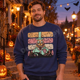 Whimsical pumpkin-headed Mayor DTF transfer in mint top hat and coat with spider brooch, retro stars, and haunted graveyard silhouette Shown on a Indigo Blue crewneck sweatshirt.