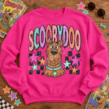 Scooby-Doo retro pop-art DTF transfer with distressed face, collar and tag, colorful patterned bubble letters spelling SCOOBYDOO, and scattered stars over a black checker pattern Shown on a Heliconia crewneck sweatshirt.