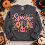 Spooky Lollie Halloween DTF transfer with pink script lettering, pattern-filled bubble letters, black bats, gold stars, and a pink jack-o-lantern Shown on a Graphite Heather crewneck sweatshirt.