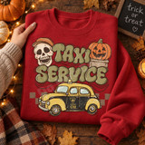 Psychic Cab Taxi Service Halloween DTF transfer with retro yellow taxi, skull in a derby hat, and jack-o-lantern in vintage bubble lettering style Shown on a Cherry Red crewneck sweatshirt.