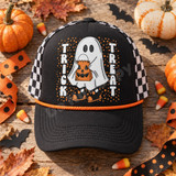 Trick or Treat ghost DTF transfer with jack-o-lantern bag and polka dot background on purple shirt Shown on a black front panel with an orange rope accent, black bill, black-and-white checkered mesh back trucker hat.