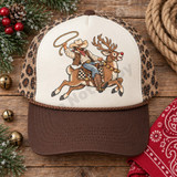 Cowboy swinging a lasso while riding Rudolick the reindeer DTF transfer, featuring western gear, studded saddle, and jingle-bell collar in illustrated style Shown on a Ivory front panel, chocolate brown bill, leopard print mesh back trucker hat.