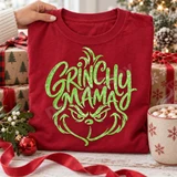 Grinchy Mama DTF transfer with green sequin-inspired script lettering shaped into a sly grinning Grinch-like face on a red shirt Shown on a Crimson t-shirt.