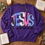 JESUS bubble-letter DTF transfer in mixed boutique patterns with black stars, above hand-lettered 'the way, the truth, the life' phrase Shown on a Purple crewneck sweatshirt.