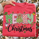 Merry Christmas DTF transfer with mixed-pattern block letters, a hand-drawn Christmas tree, holly, gingerbread man, gift box, candy cane, stocking, jingle bells, and red and green snowflakes on a red shirt Shown on a Watermelon t-shirt.