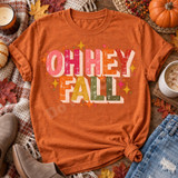 Oh Hey Fall retro distressed lettering DTF transfer in pink, orange, mustard and olive with sparkly star accents Shown on a Yam t-shirt.