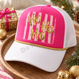 Ho Ho Ho DTF transfer with gold brush script lettering on a pink and light pink striped background, shown on a pink Christmas t-shirt Shown on a hot pink foam front, white pre-curved bill, white mesh back, gold rope trucker hat.