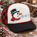 Cartoon snowman head DTF transfer wearing a black top hat with holly and red striped scarf, blowing snowflakes in a Pac-Man style design Shown on a Black / Cardinal Red trucker hat.