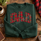 DAD DTF transfer in large arched collegiate block letters filled with red tartan plaid pattern on a blue t-shirt Shown on a Forest crewneck sweatshirt.