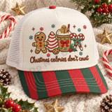 Christmas calories don't count DTF transfer with embroidered-style gingerbread man, striped candy tree, cocoa mug, and candy cane holiday design Shown on a Ivory front panel, red and green striped pre-curved bill, white mesh back trucker hat.