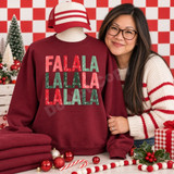 Fa La La La La Christmas DTF transfer in retro distressed block letters cycling through coral, red, and green tones Shown on a Garnet crewneck sweatshirt.