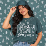Frosty Season DTF transfer with chalky white line-art snowman peeking through FROSTY lettering and script season text, surrounded by sketchy snowflakes Shown on a Blue Spruce t-shirt.