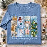 It's The Most Wonderful Time Of The Year Christmas DTF transfer with embroidered-yarn style mouse king, ballerina, nutcracker soldier, and pom-pom pine tree panels Shown on a China Blue t-shirt.