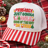 Probably Just Gonna Jingle Some Of The Way Im Tired Christmas DTF transfer in stacked polka-dot varsity lettering with hand-drawn ornaments, bell, candy cane, stocking, stars, and mini Christmas trees Shown on a white front panel, red and white striped bill, cream rope, white mesh back trucker hat.