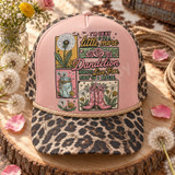 Boho western DTF transfer with dandelions, pink roses, mason jar bouquet, and pink cowboy boots around a dandelion-themed quote Shown on a blush pink front panel, tan rope, leopard print mesh back trucker hat.