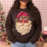 Whimsical crocheted-look Santa face DTF transfer with hot pink knit hat, leopard print headband and earmuffs, pink heart-shaped leopard sunglasses, and a looped cream yarn beard Shown on a Dark Chocolate crewneck sweatshirt.
