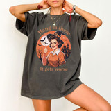 Hang In There It Gets Worse DTF Transfer | Retro Witch Halloween Design, retro Halloween graphic featuring a smiling witch, bats, moon, and haunted house printed on a charcoal oversized T-shirt