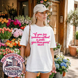 If You See Someone Without A Smile Give Them Yours DTF Transfer | Inspirational Quote Design, pink inspirational quote printed on a white T-shirt worn by a woman standing outside a flower shop
