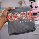 Coke Girlie DTF transfer with collage-style Coca-Cola print letters and white script lettering on a dark gray shirt