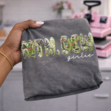 Mtn Dew Girlie DTF transfer with collage-style Mountain Dew print letters and white script lettering on a gray shirt