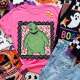Green stitched sack monster Halloween DTF transfer with stars on a pink checkered background framed in a scalloped polka dot border