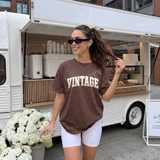 VINTAGE collegiate varsity letter DTF transfer in distressed cream lettering on a brown t-shirt