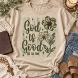 God Is Good All The Time DTF transfer with camo-print and leopard-print daisy flowers on a sage striped background Shown on a Sandstone t-shirt.