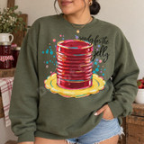 Ready for the Jelly DTF Transfer | Painterly Mason Jar Canning Design, colorful painterly red jelly jar on a yellow plate with playful lettering printed on an olive green sweatshirt