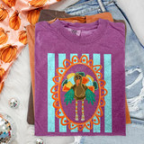Quirky Turkey DTF Transfer | Retro Thanksgiving Design with Scalloped Frame, colorful retro turkey in an orange scalloped oval on a purple T-shirt with aqua stripes, styled with folded shirts and autumn pumpkin fabric