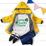 Little Lucky Charm PLAID INFANT Screen Print Transfer, baby outfit with a white t-shirt and a yellow jacket, displayed on a white wooden background with colorful bunting.