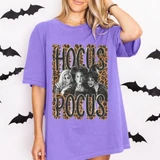 Hocus Pocus Witches DTF Transfer | Leopard Print Halloween Design, leopard-print Hocus Pocus graphic featuring three witches on a purple T-shirt modeled against a Halloween bat backdrop.