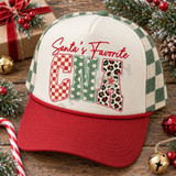 Santa's Favorite CNA Christmas DTF transfer with red checkered, green polka dot, and leopard print block letters and a striped star accent Shown on a ivory front panel, brick red bill, green and cream checkered mesh back trucker hat.