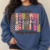 God Is Faithful In Every Season DTF Transfer | Boho Faith Design, colorful boho patchwork faith design printed on a blue sweatshirt modeled by a woman