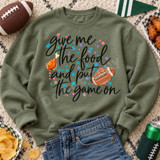 Give Me the Food and Put the Game On DTF Transfer | Funny Football Game Day Design, colorful football and chicken drumstick lettering design displayed on an olive green sweatshirt with game day snacks and football decor