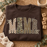 Boho Mama DTF Transfer | Mixed Pattern Block Letter Design, bold “MAMA” lettering with checkerboard, camouflage, leopard print, and polka dot patterns, outlined in cream with decorative bows, displayed on a brown sweatshirt.