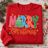 Merry Christmas Patterned Block Letters DTF Transfer | Christmas Tree Design, colorful patterned “Merry Christmas” lettering with a decorated Christmas tree printed on a red sweatshirt, styled with holiday ornaments and greenery.
