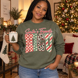 Santa's Favorite NICU Christmas DTF transfer with red script lettering and block letters filled in checkerboard, polka dot, leopard, and candy-cane stripe patterns Shown on a Military Green crewneck sweatshirt.