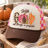 With God All Things Are Possible fall DTF transfer featuring a polka-dot G, patterned pumpkins forming the O with a pink gingham bow, and a cross-patterned D Shown on a cream foam front with brown bill and pink/orange checkered mesh back trucker hat.