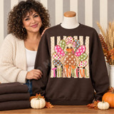 Thankful Turkey DTF Transfer | Whimsical Patchwork Thanksgiving Design, colorful patchwork turkey with “THANKFUL” lettering displayed on a brown sweatshirt, styled with autumn pumpkins and leaves.