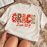 GRACE DTF transfer in mixed red, cream, and leopard print applique-style letters with bows and a red script 2 Cor 12:9 Bible verse underneath Shown on a Ivory t-shirt.