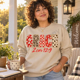 GRACE DTF transfer in mixed red, cream, and leopard print applique-style letters with bows and a red script 2 Cor 12:9 Bible verse underneath Shown on a Sand crewneck sweatshirt.