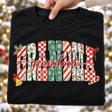 Grandma Christmas DTF transfer with block letters in candy cane, checkerboard, snowflake, and leopard patterns, topped with red cursive script and holly, bow, bell, and candy cane accents Shown on a Black t-shirt.