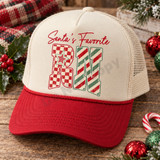 Santa's Favorite RN Christmas DTF transfer with red script lettering, checkerboard R with striped star, and candy-cane striped N Shown on a cream front panel, red bill, cream mesh back trucker hat.