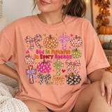 God Is Faithful In Every Season DTF transfer with polka-dot and floral pumpkins, plaid bows, and floral crosses in a colorful hand-lettered fall faith design Shown on a Peachy t-shirt.