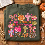 God Is Faithful In Every Season DTF Transfer | Fall Faith Pumpkin & Cross Design, colorful fall-themed faith design with pumpkins, crosses, bows, and the phrase “God Is Faithful In Every Season” displayed on a folded dark green shirt