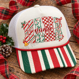 NANA Christmas DTF transfer with candy cane stripe, holly, checkerboard, and leopard print letters, holly leaves, a red bow, gold jingle bell, candy cane, and red script 'nana' overlay Shown on a ivory cream front panel with red and green striped bill and white mesh back trucker hat.